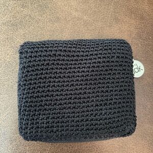 The Sak Black Crochet Zip Wallet with Silver Logo Charm